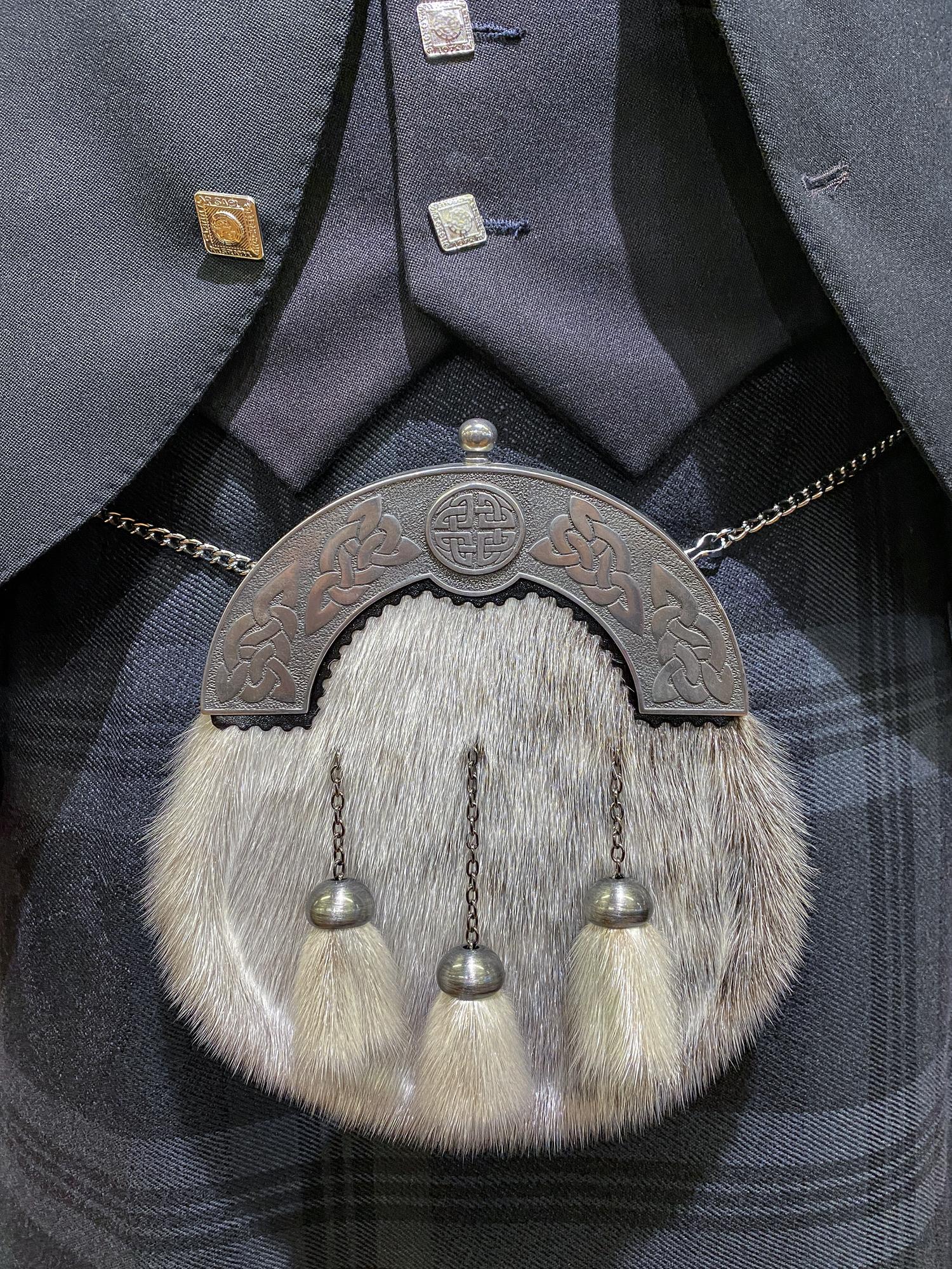 large editorial shot of embroidered jacket cuff with metallic threads